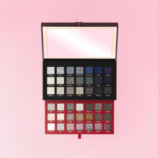 P.Louise Mystic Moonlight halloween makeup eyeshadow palette with various shades on a pink background