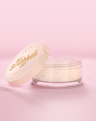 Jar of P.Louise All Scrubbed Up Body Scrub in coconut cake against a pink background