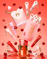 Set regalo Pink XL Protect Your Pout che si apre circondato da ciliegie e balsami per labbra rosa e rossi su sfondo rosa