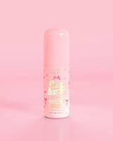 Bottiglia rosa di P.Louise Pure Intentions Purify & Brightening Lotion con disegni di fiocchi rossi su sfondo rosa