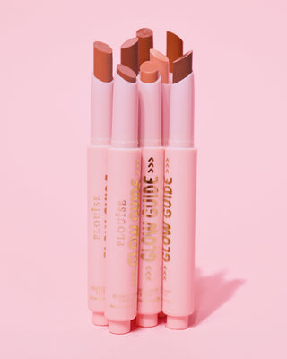 Shot showing the P.Louise Glow Guide Glossy Lipstick Balsm in full without lips showing the range of colours on a pink background