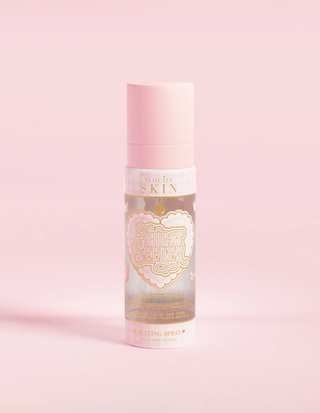 A pink spray bottle labeled 'P.Louise SKIN' with a depiction of a heart and some floral elements, containing a hydrating setting spray.
